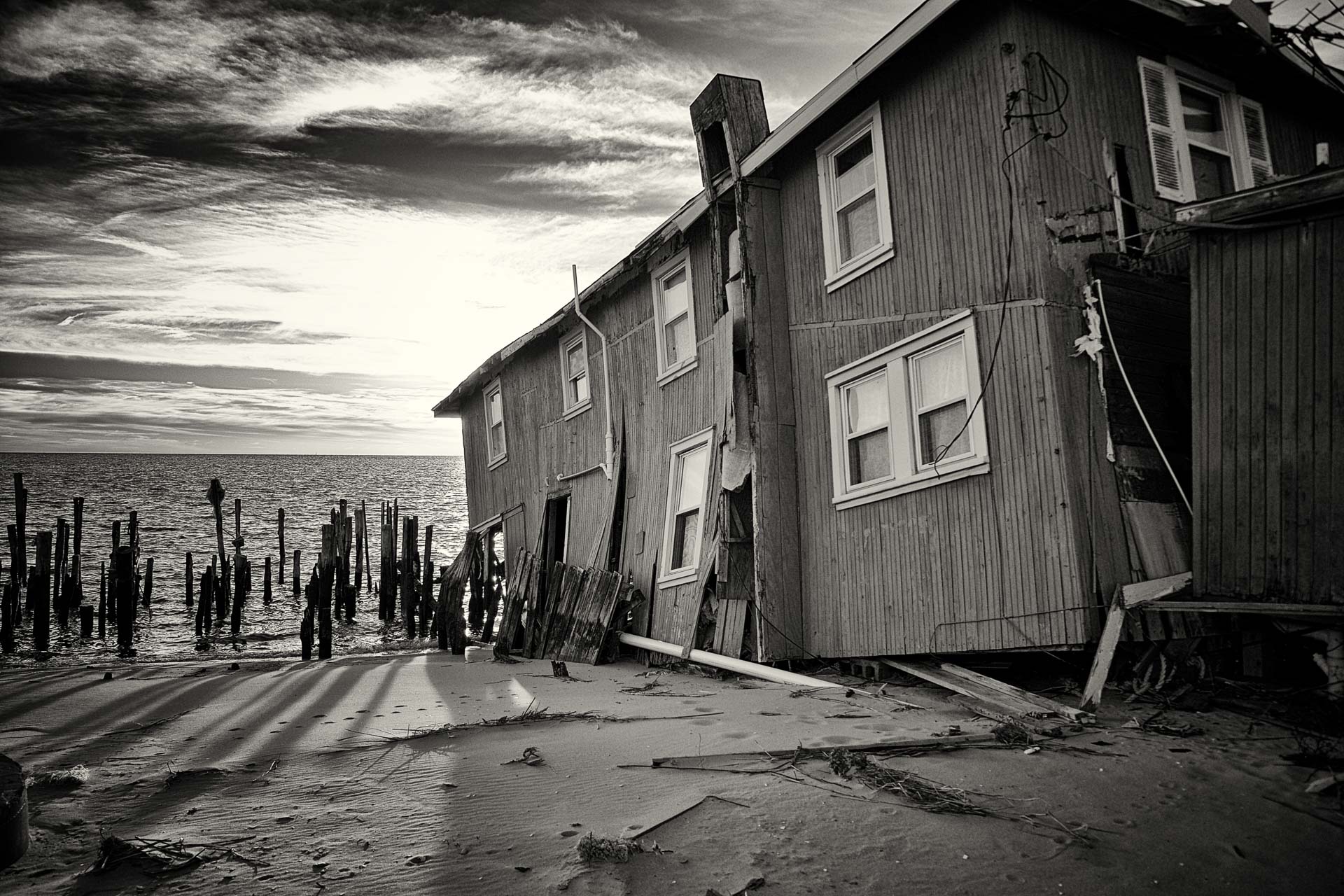 House in Fortescue falls into the sea after permanent damage from hurricane Sandy. Fortescue, also known as the "weakfish capital of the world" was severely damaged by the hurricane with many households suffering structural damage. Without state aid, its residents have been forced to leave and is now a ghost town, with most of its properties for sale.
